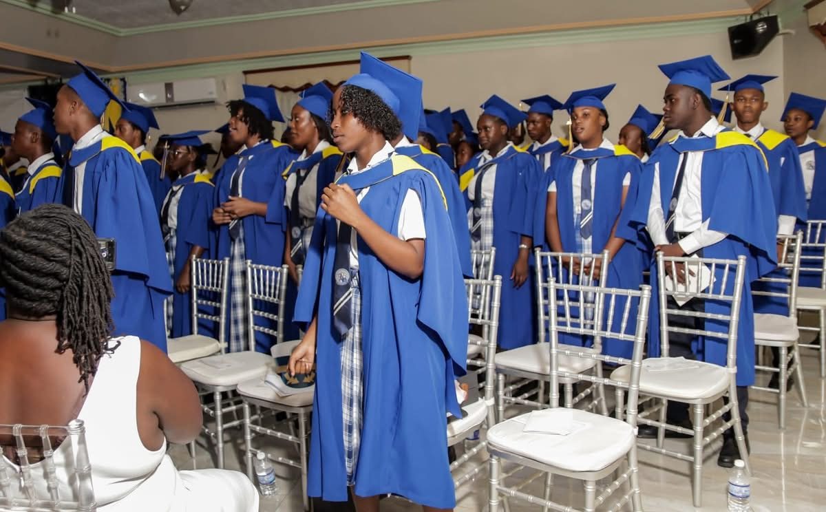 Graduates standing during ceremony